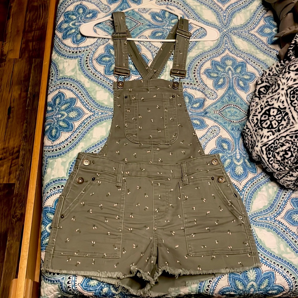 Dark sage green overall with small soft pink tulip pattern.